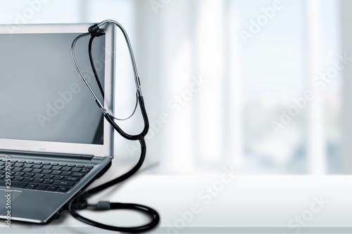 Laptop diagnosis with  stethoscope  on background