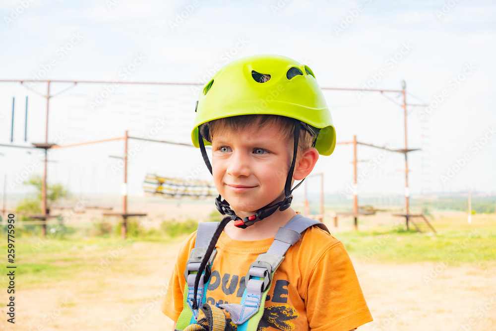 A boy in a yellow helmet in an extreme park. A boy in a yellow helmet in an extreme park.