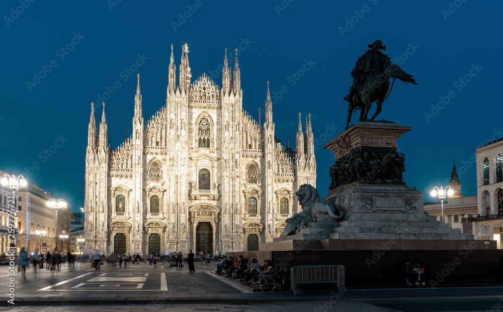 Milan Cathedral or Duomo di Milano on Cathedral Square at night, Italy. This place is a main tourist attraction of Milan. Panorama of old architecture of Milan in evening. Cityscape of Milan at dusk.