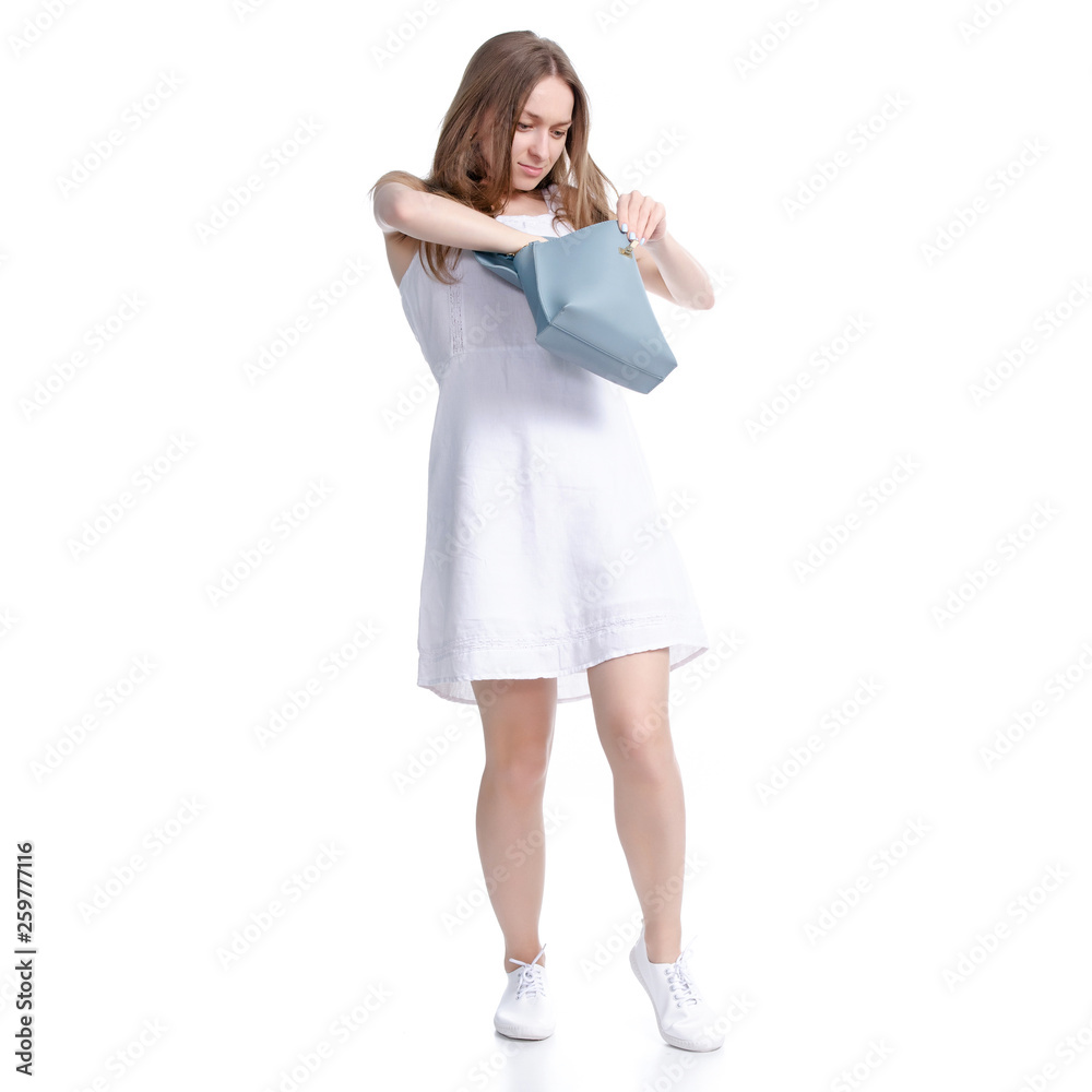 Woman in white dress is looking for something in her bag on white background isolation Woman in white dress is looking for something in her bag on white background isolation