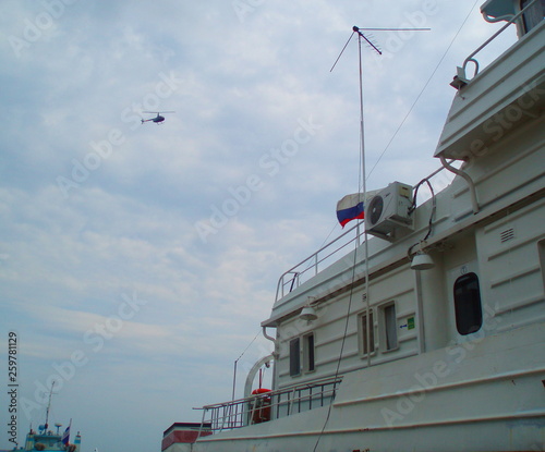 helicopter flies over the ship © Алексей Анисимов