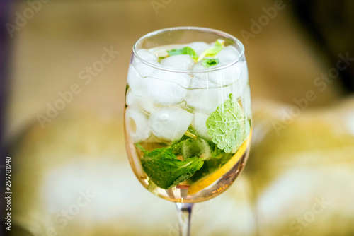 Glass with delicious fresh homemade mojito on blurred background