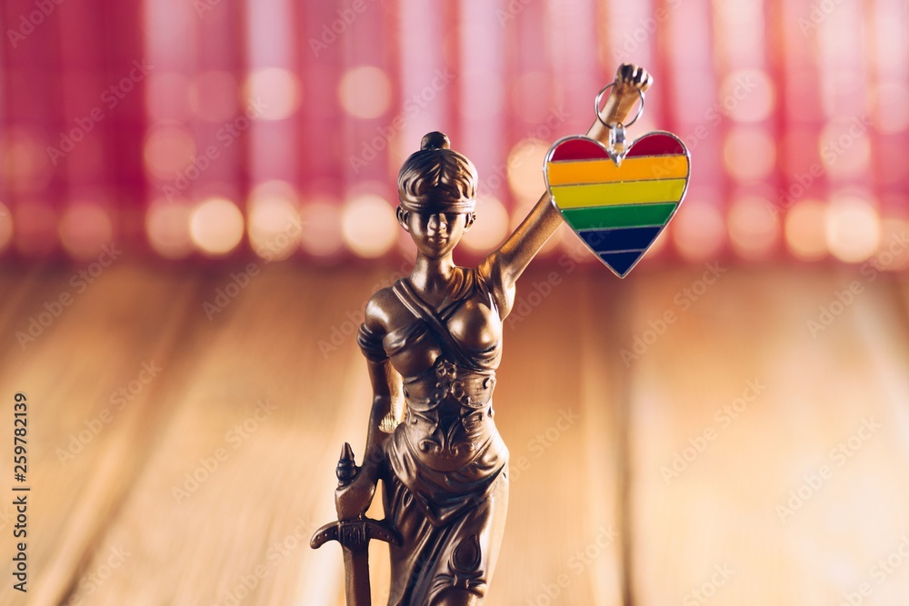 Statue of Temide - symbol of law and justice holding heart with lgbt colours