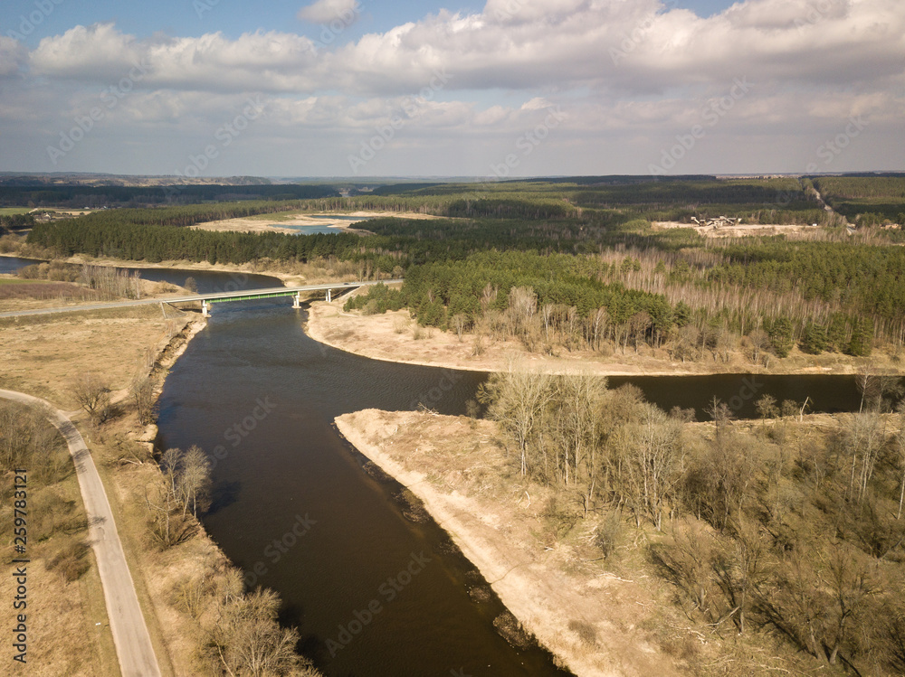 Aerial view of Nemunas river in Lithuania. Bridge over the river. Early spring scenery.