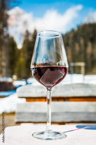 A glass of red Cabernet wine in a lodge in Cortina d'Ampezzo, Dolomites, Italy