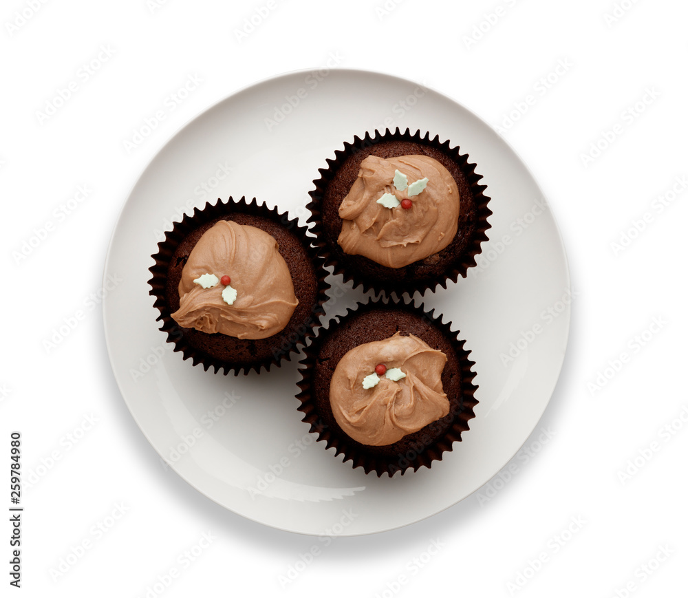 Cut out image of a white plate with 3 chocolate fairy cakes Cut out image of a white plate with 3 chocolate fairy cakes
