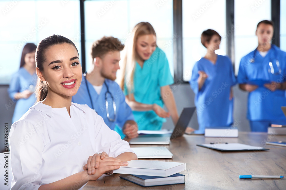 Smart medical student with her classmates in college