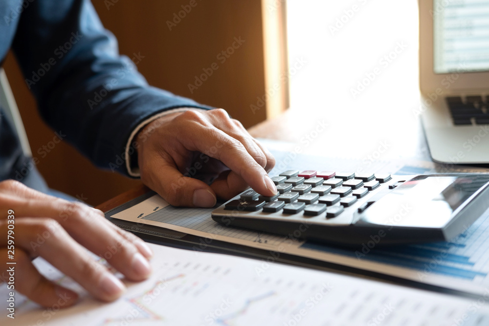 Businessman accountant working new project on laptop computer with report document and analyze document graph and diagram, doing finance making notes statistics Businessman accountant working new project on laptop computer with report document and analyze document graph and diagram, doing finance making notes statistics