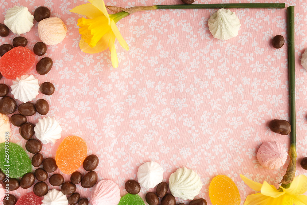 chocolates with peanuts, marshmallows and marmalade on a fabric background chocolates with peanuts, marshmallows and marmalade on a fabric background