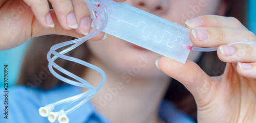 Fotografie Girl holding polymers Bio-MEMS biomedical microelectromechanical systems / LOC l