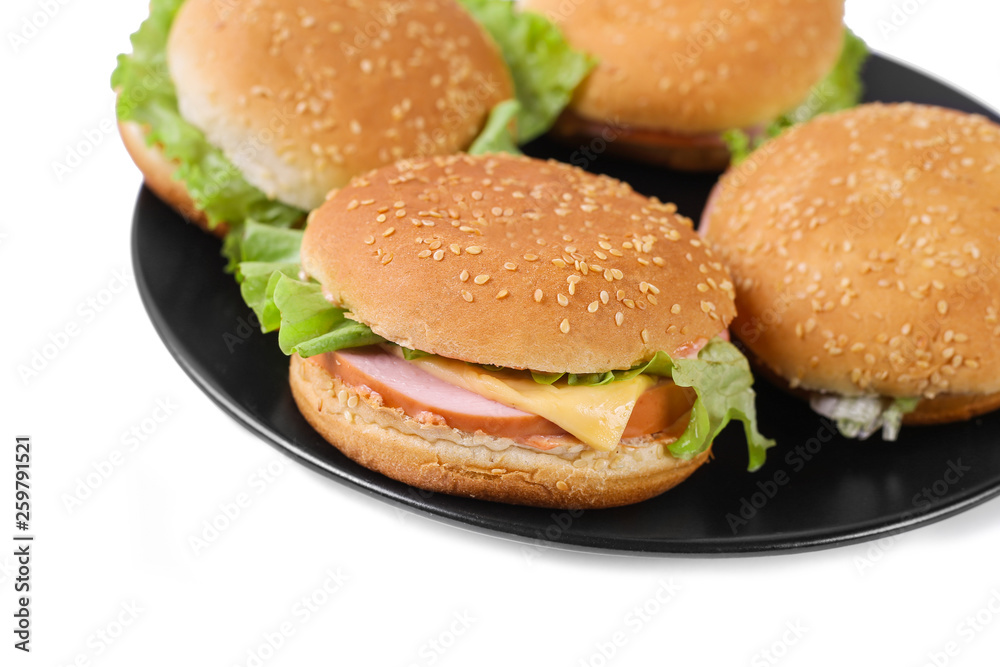 Hamburger with sausage and cheese with fresh lettuce. Four hamburgers on black plate. Isolated. Top view Hamburger with sausage and cheese with fresh lettuce. Four hamburgers on black plate. Isolated. Top view
