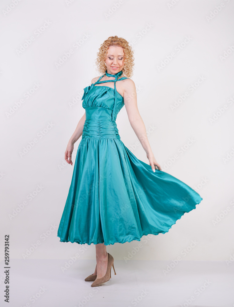 slim airy girl in flying blue evening dress on white background in Studio slim airy girl in flying blue evening dress on white background in Studio