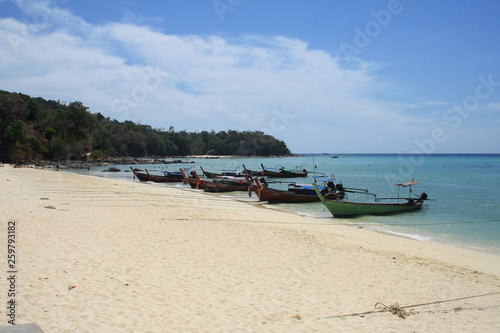 February 16, 2019. Krabi, Phi Phi island, Thailand. Sea view, yellow sand beach, boats at the shore. © taushka