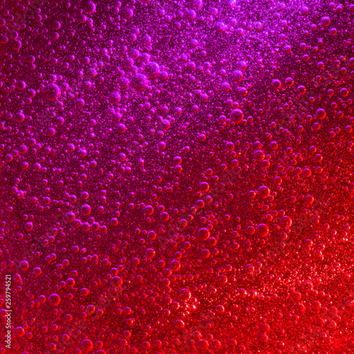 Red & purple liquid with impressive quantity of sparkling air bubbles.
