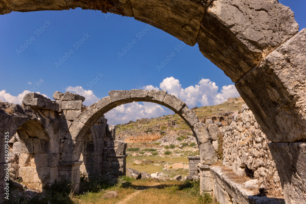Tlos, Turkey.  Arch and ruins of the ancient city of Tlawa in front of blue sky.