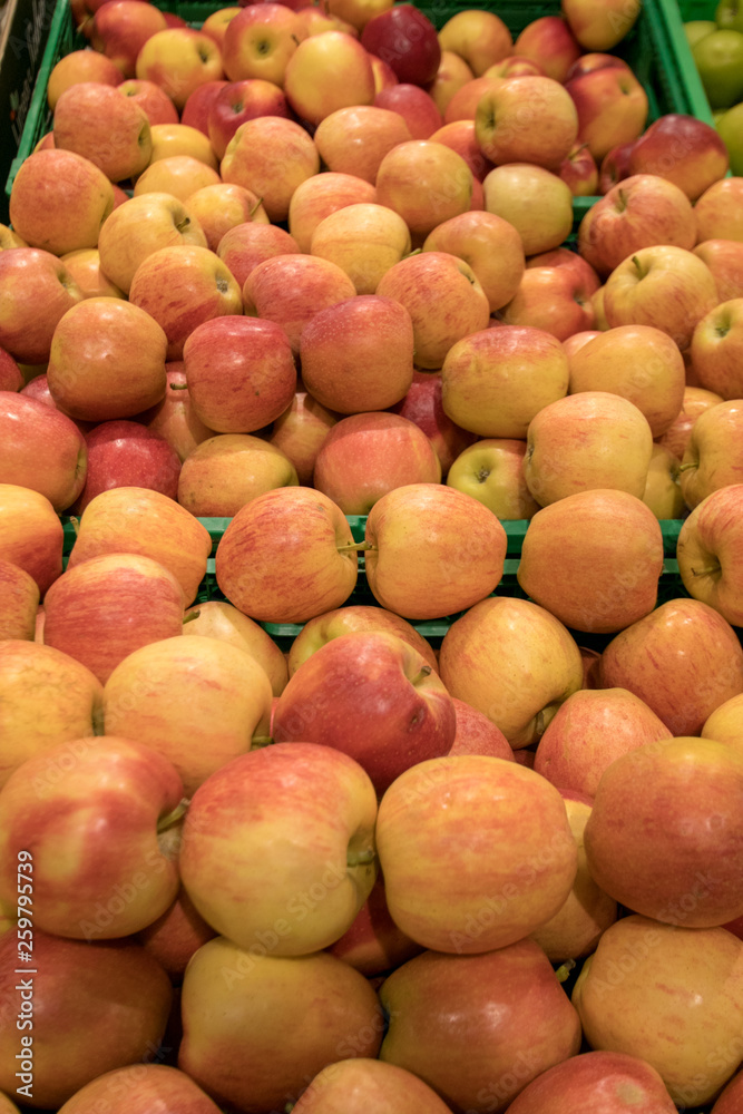 A lot of red apple fruit in a basket in the market