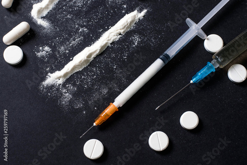 Hard drugs on dark table. heroin, cocaine, amphetamine, ecstasy, pills and more. Creative idea. Drugs. Sad. Die. Illness