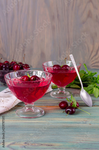 Jelly from a sweet cherry on a wooden background