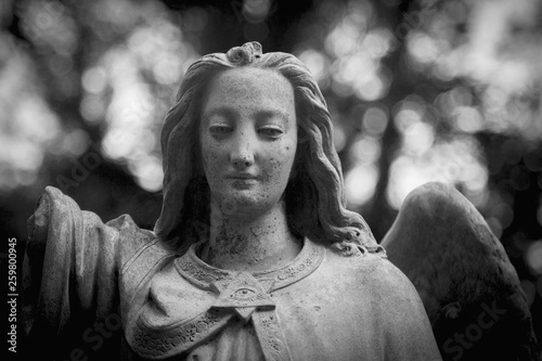 Antique statue of sad angel as a symbol of eternity, life and death. Religion tradition.