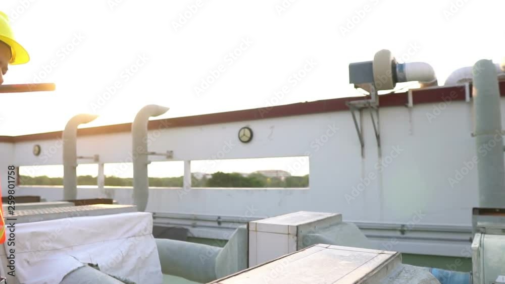 Asian worker working on the rooftop,Thailand people,Labor day concept,The working time of the engineers. Asian worker working on the rooftop,Thailand people,Labor day concept,The working time of the engineers.