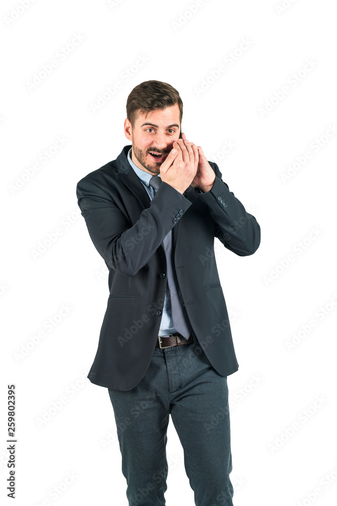 Young handsome businessman is on phone talk creating gossips. Isolated on white background. Concept of corporate secret. Young handsome businessman is on phone talk creating gossips. Isolated on white background. Concept of corporate secret.