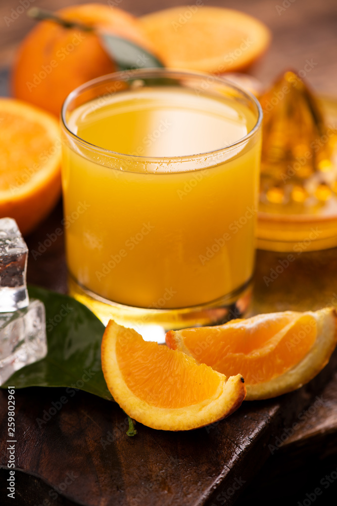 Glass of orange juice on wooden table Glass of orange juice on wooden table