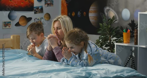 Mother and children praying together photo