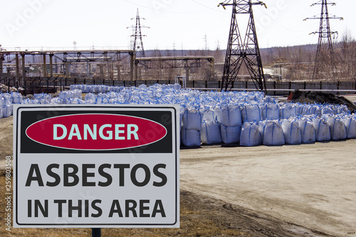 the danger sign and large asbestos bags.