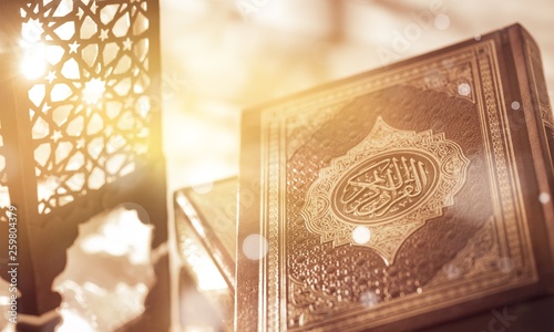 Islamic Book Koran with rosary on grey