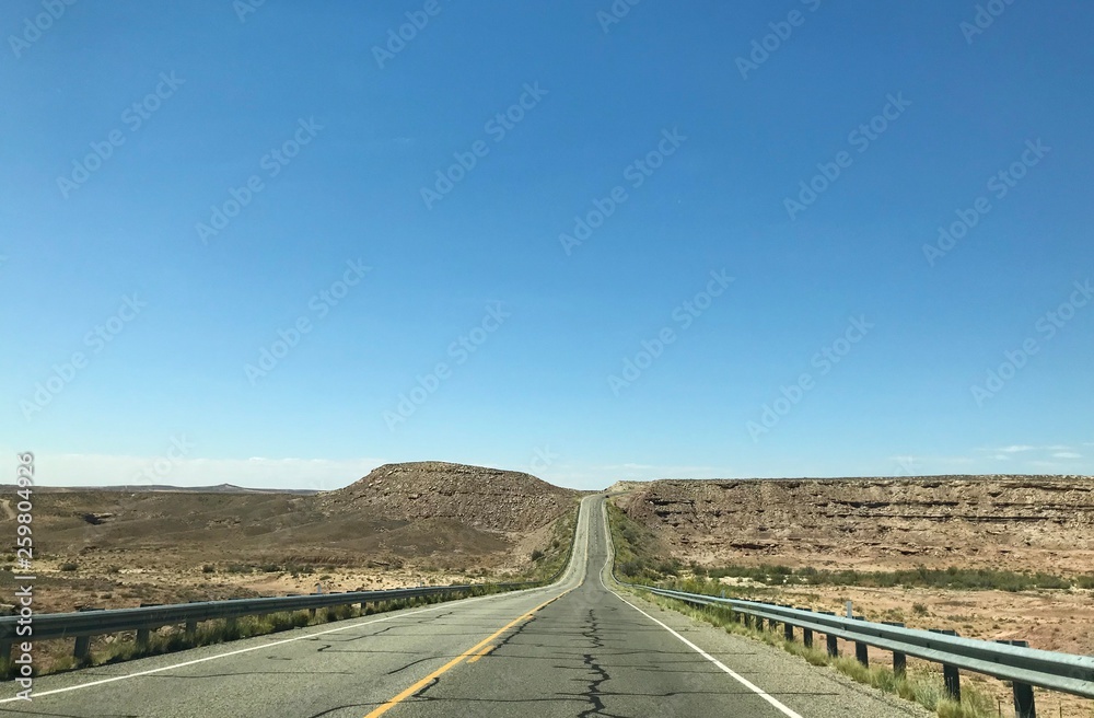 An empty desert highway photo taken on a beautiful sunny day