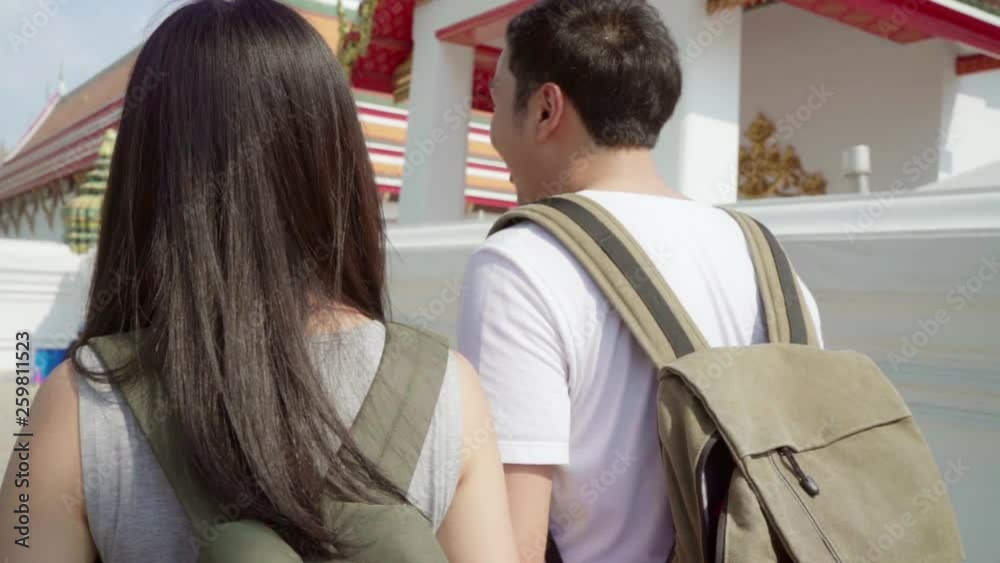 Slow motion - Traveler Asian couple traveling and walking in Bangkok, Thailand, sweet couple feeling happy spending sweet time in holiday trip. Lifestyle couple travel in city concept. Slow motion - Traveler Asian couple traveling and walking in Bangkok, Thailand, sweet couple feeling happy spending sweet time in holiday trip. Lifestyle couple travel in city concept.