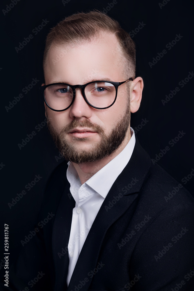 Handsome young businessman in glasses on black background Handsome young businessman in glasses on black background