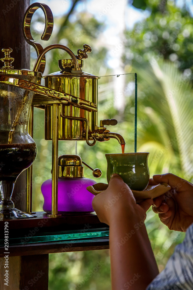 Making legendary coffee, Kopi Luwak, in a vintage syphon. Bali