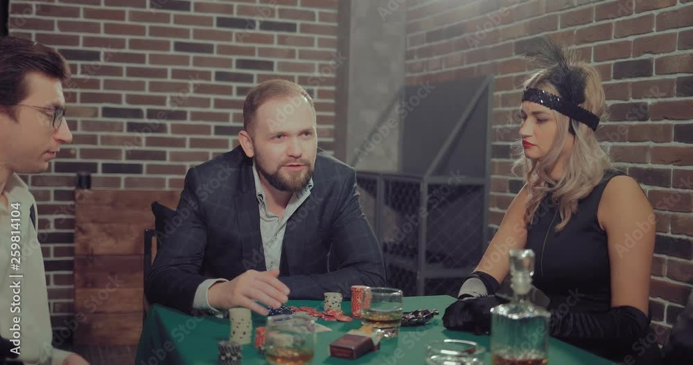 Mafiosi sit at the playing table, the man says. Gaming chips, alcohol, cigars are on the green table.