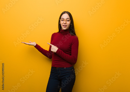 Intellectual young girl holding something with hand