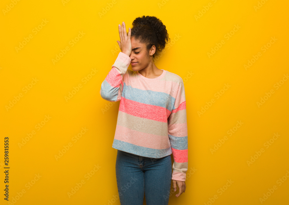 Young black african american girl with blue eyes forgetful, realize something