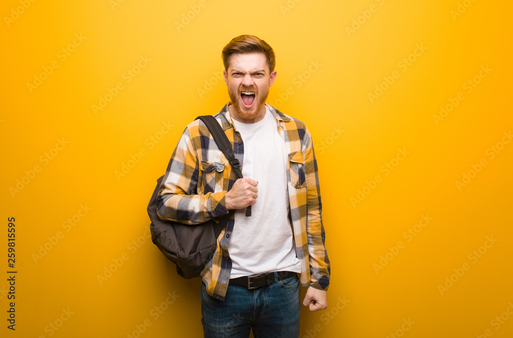 Young redhead student man screaming very angry and aggressive Young redhead student man screaming very angry and aggressive