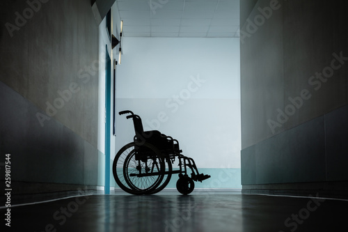 Empty Wheel Chair In Hospital Corridor