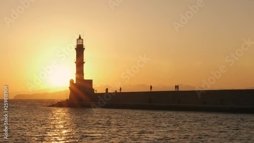 Sunset over The Venetian era harbour and lighthouse at the Mediterranean port of Chania, Crete