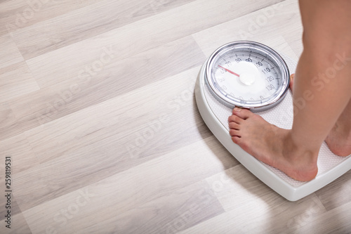 Woman Standing On Weighting Scale