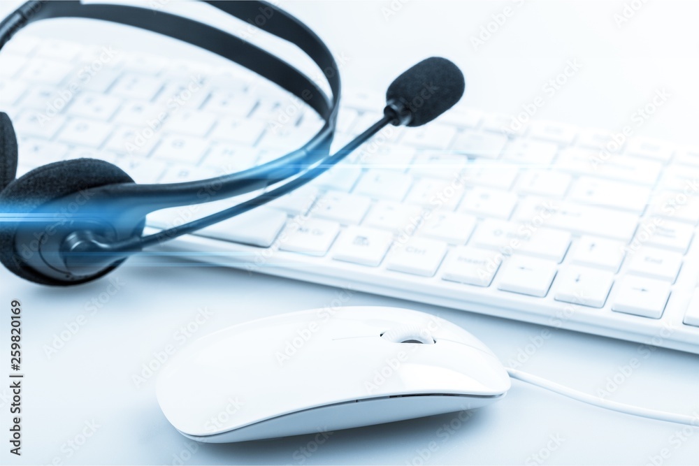 Computer headphones with laptop on background Computer headphones with laptop on background