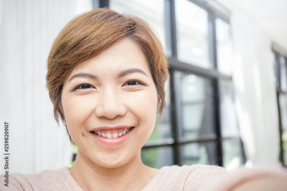 Pretty asian woman take a self portrait with her smart phone Asian girl selfie, isolated on white background Pretty asian woman take a self portrait with her smart phone Asian girl selfie, isolated on white background