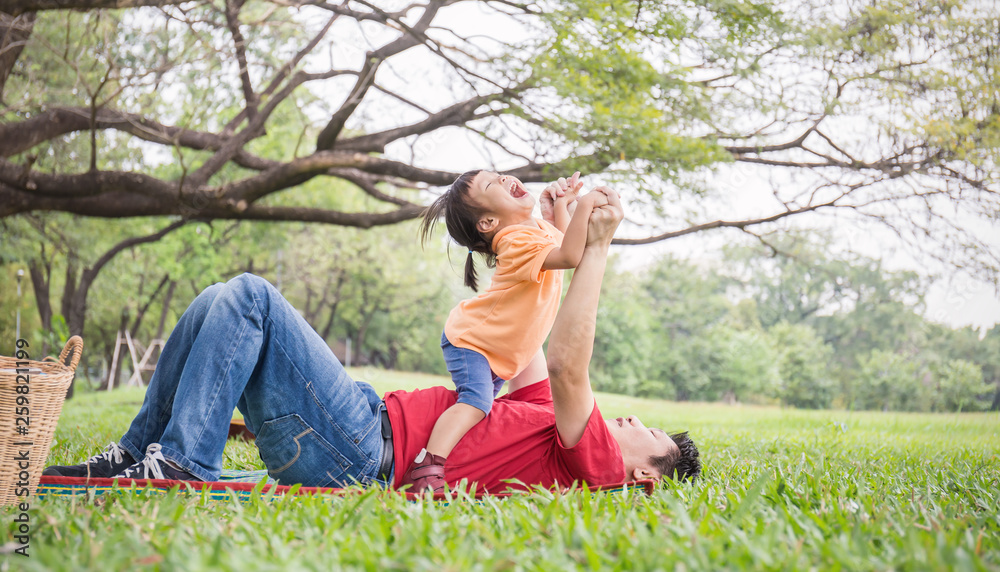 Happy asian father and daughter playing in the park. Asian man and ...