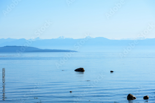 Serene Coastline with view of Rocky mountains, morning view, British Columbia, Canada,  photo