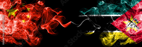 China vs Mozambique, Mozambican smoke flags placed side by side. Thick colored silky smoke flags of Chinese and Mozambique, Mozambican