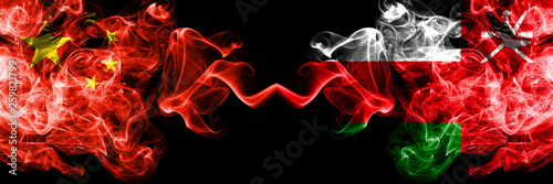 China vs Oman, Omani smoke flags placed side by side. Thick colored silky smoke flags of Chinese and Oman, Omani