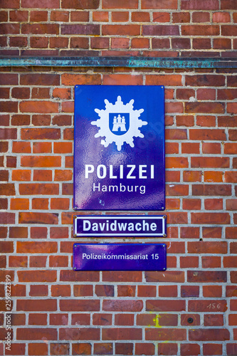 Hamburg, Germany - June 25, 2014: Street Plate on the Davidwache building, the best known police station in Hamburg, located in the St. Pauli quarter near Reeperbahn. Hamburg Police Department 15 photo