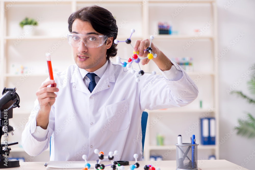 Young male scientist working in the lab Young male scientist working in the lab
