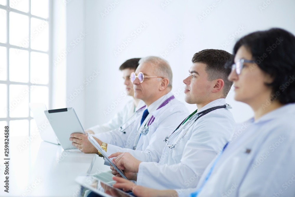 Medical team sitting and discussing at table Medical team sitting and discussing at table