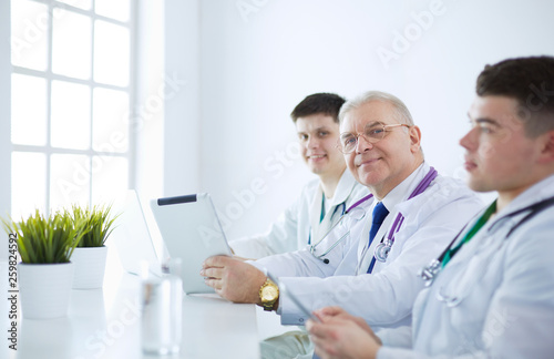 Medical team sitting and discussing at table